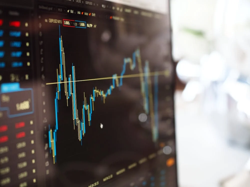 Dollar bills over a stock graphic